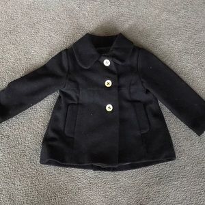 Black children place pea coat with 3 gold buttons